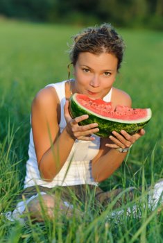 woman enjoying eating a watermelon